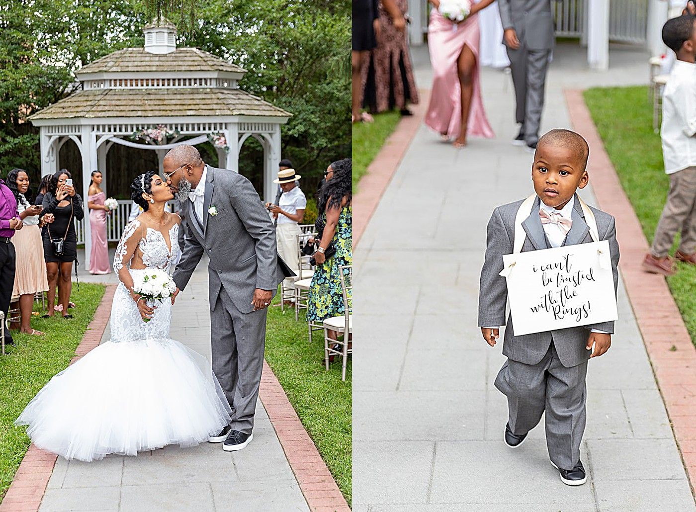 Bride and groom share a kiss at outdoor wedding ceremony while young ring bearer holds a sign on the brick path.
