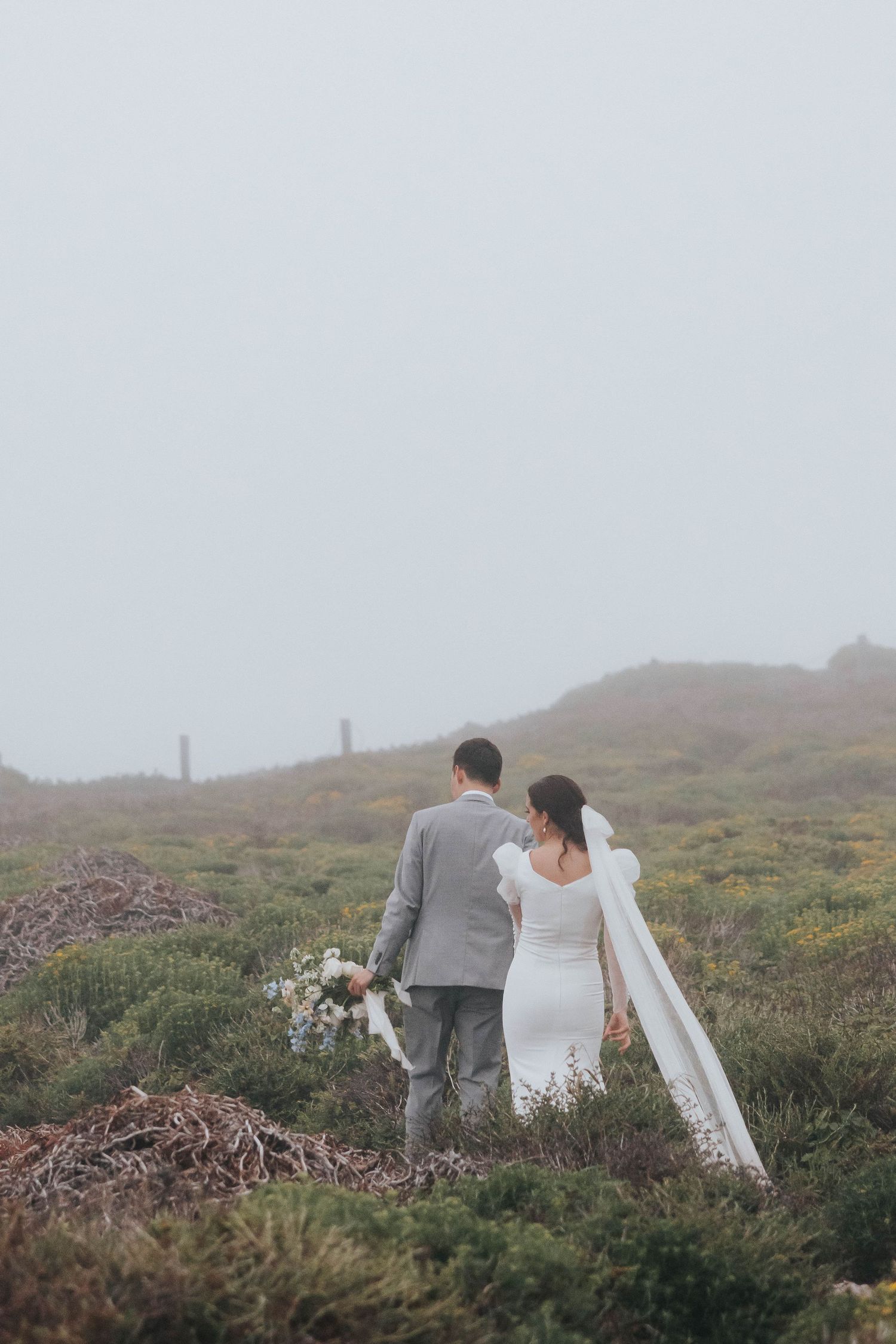 A couples walks into the distance during their destination elopement near Big Sur, California.