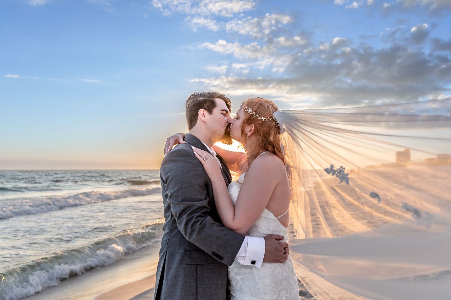 Romantic beachside wedding couple embracing during golden hour sunset.