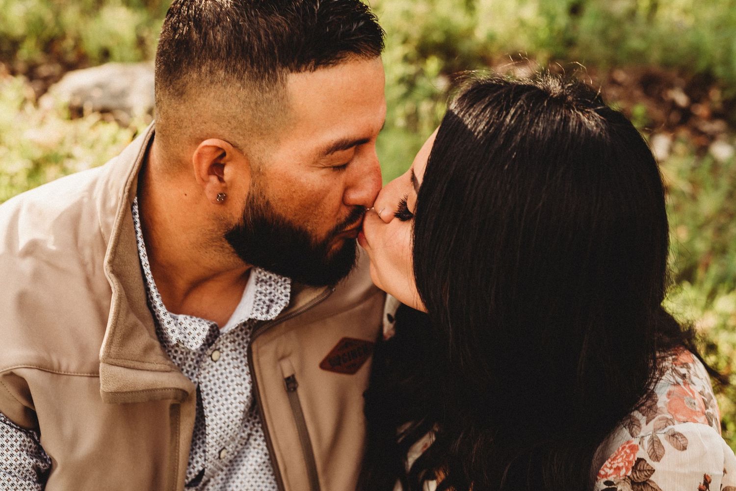 Intimate romantic moment between couple during outdoor portrait session.