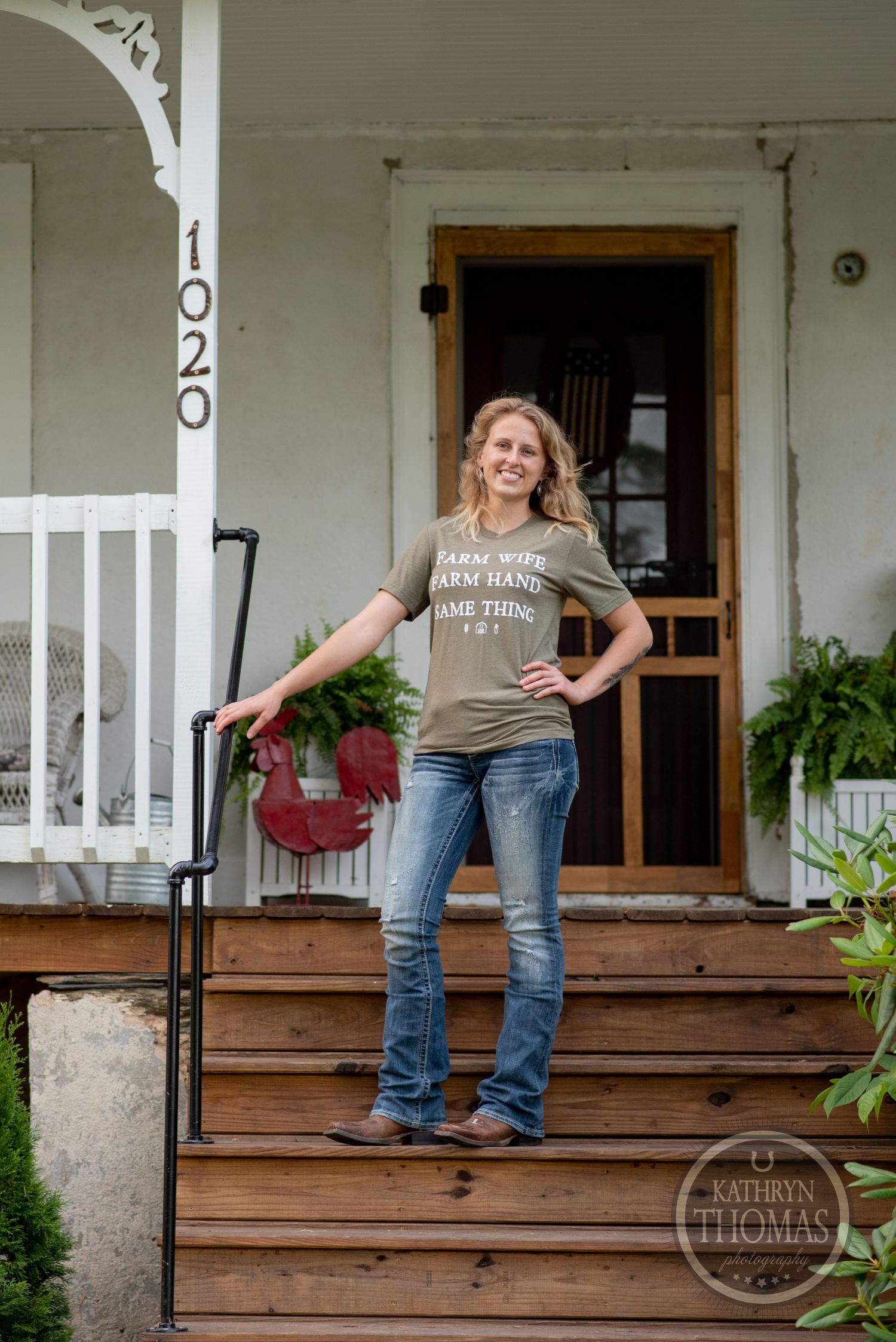 Standing on wooden porch steps with house number 1023 visible in rustic farmhouse setting.