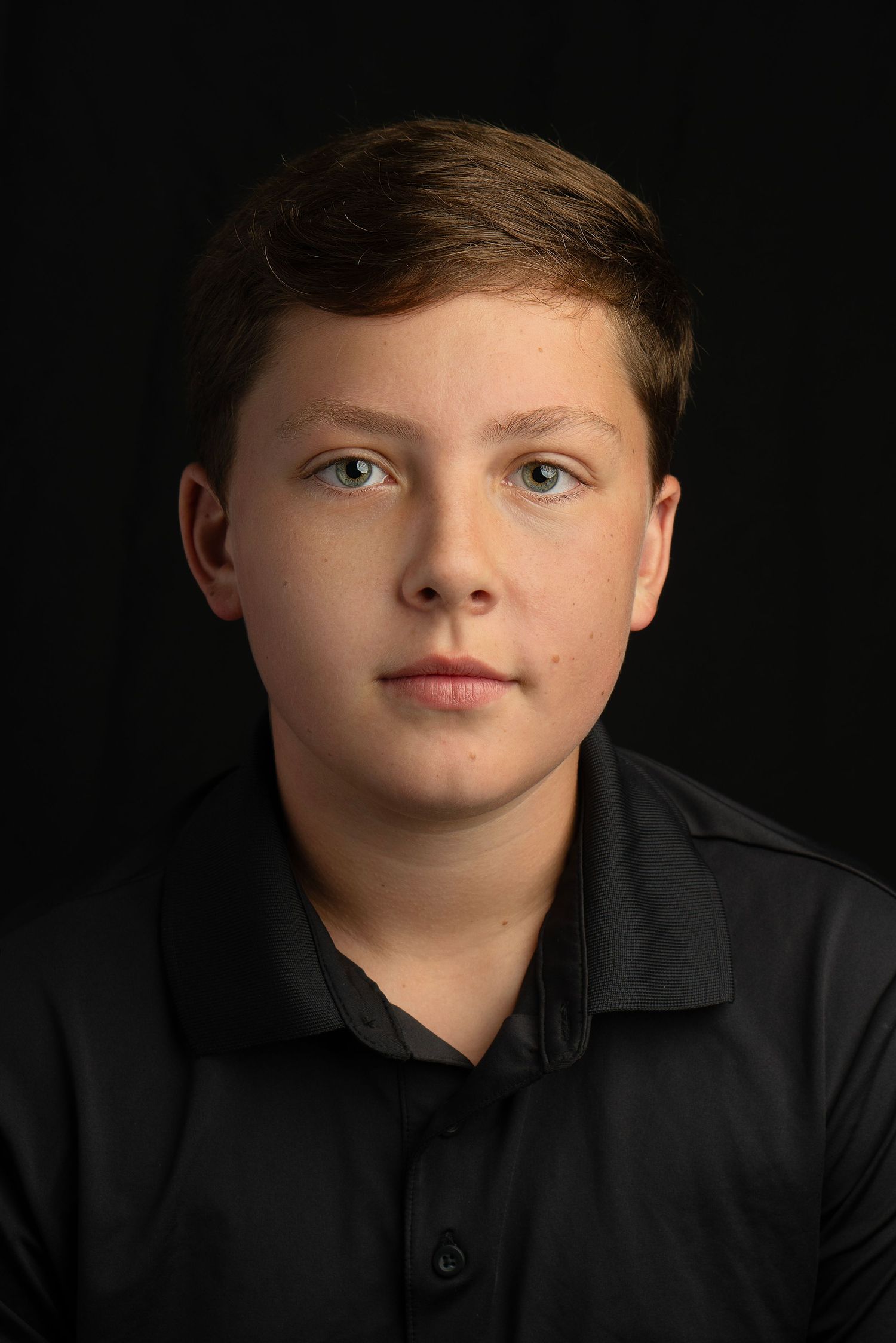 timeless portrait of boy on black background