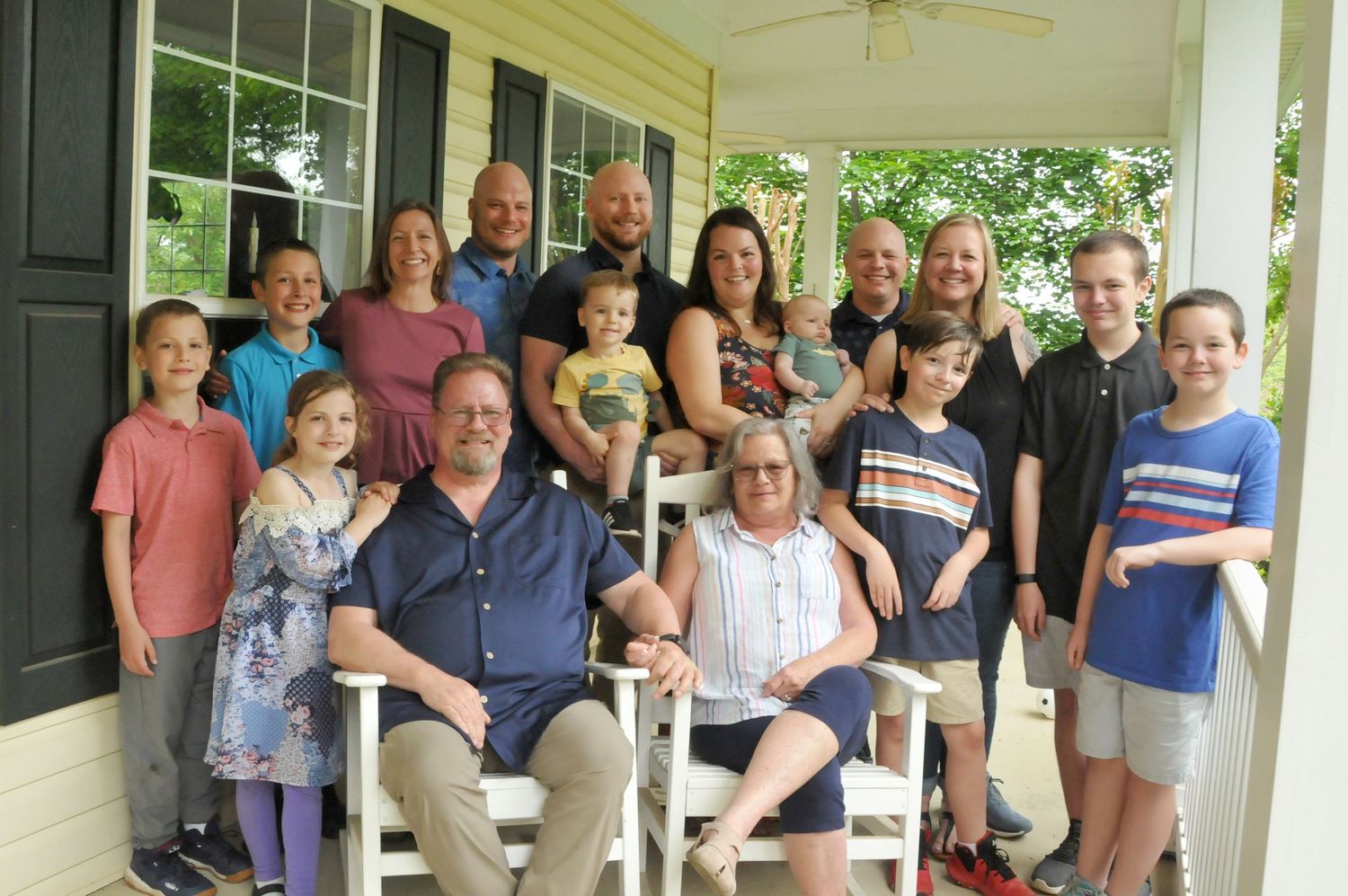 Extended family photo on a porch