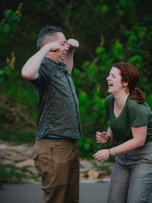 A playful sequence of candid moments between two people sharing laughter and casual conversation against a green background.