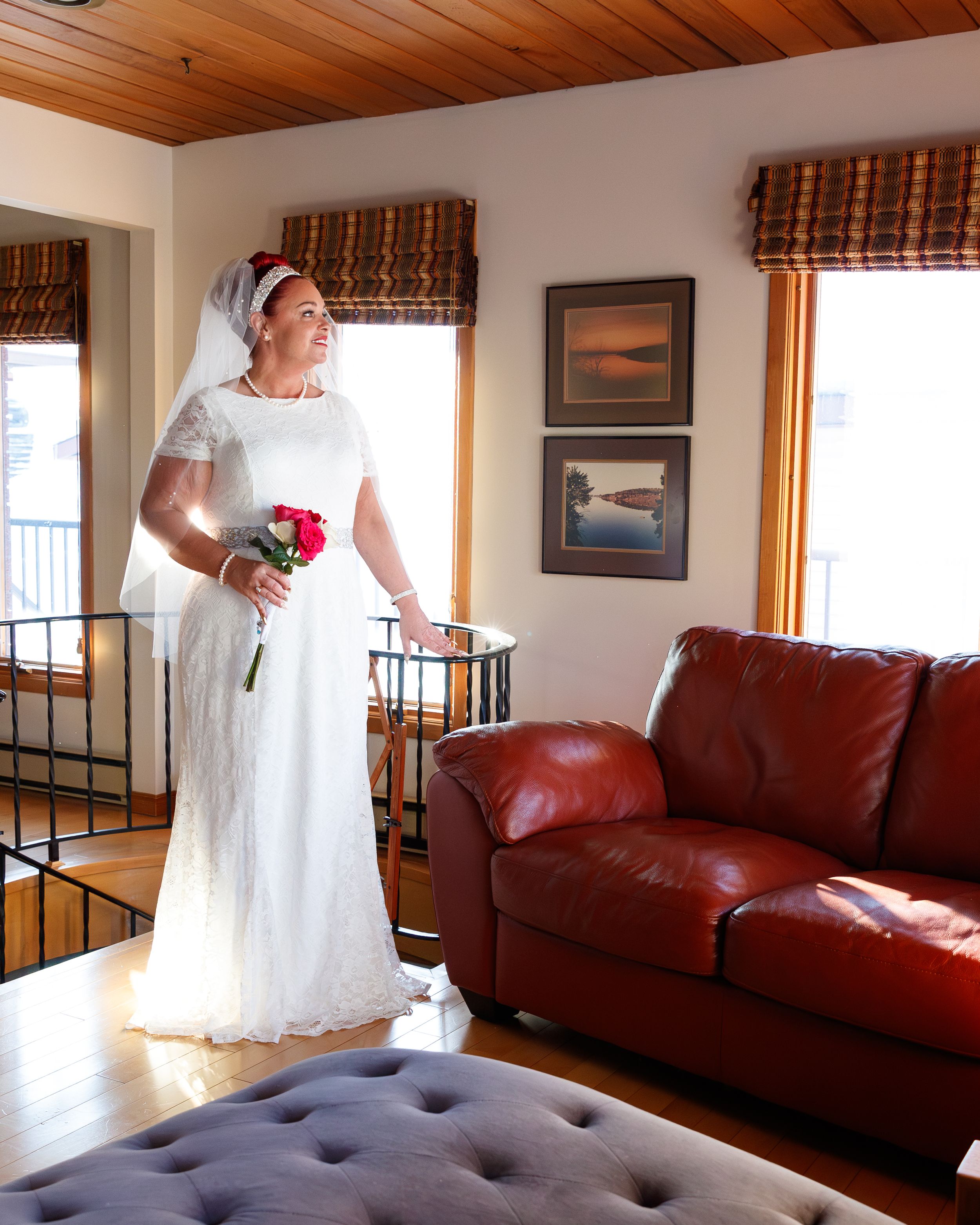 A sequence of four wedding preparation photos showing white dress details and a burgundy leather couch in a sunlit room.