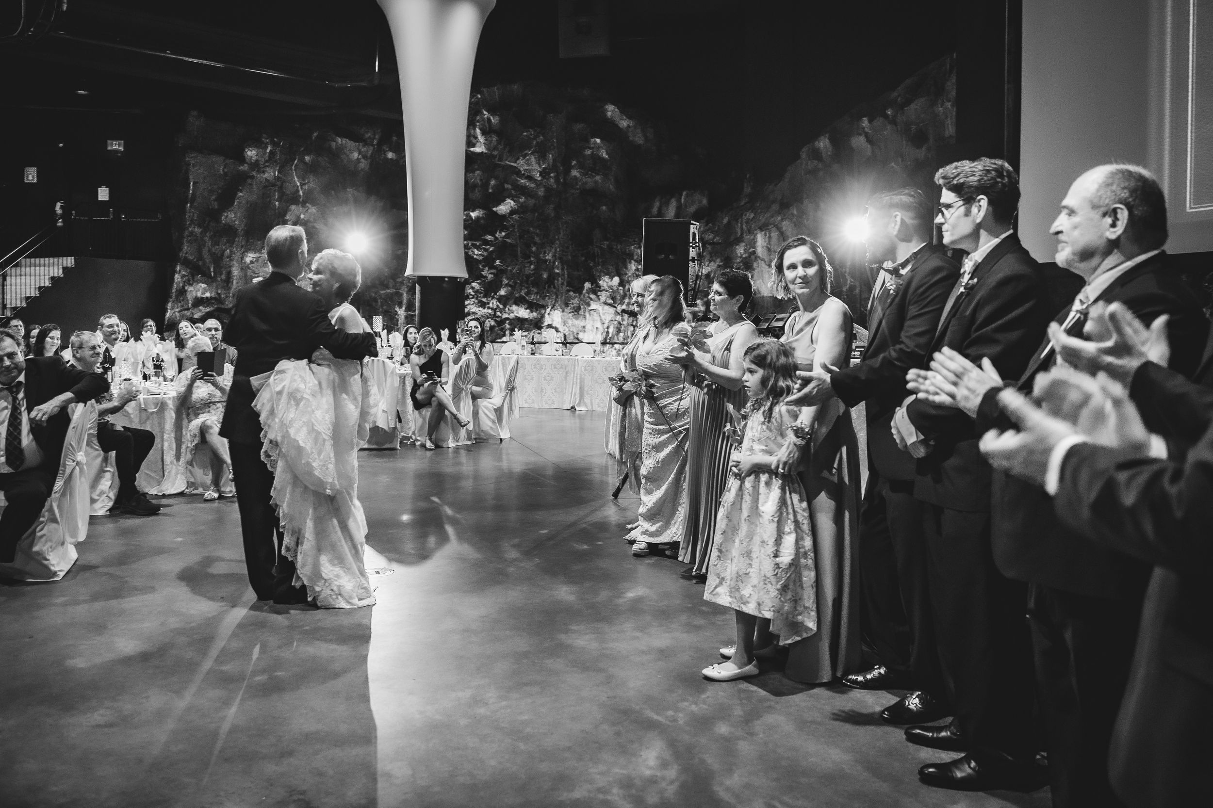 A series of black and white wedding reception photos showing dancing and celebrations on the dance floor.