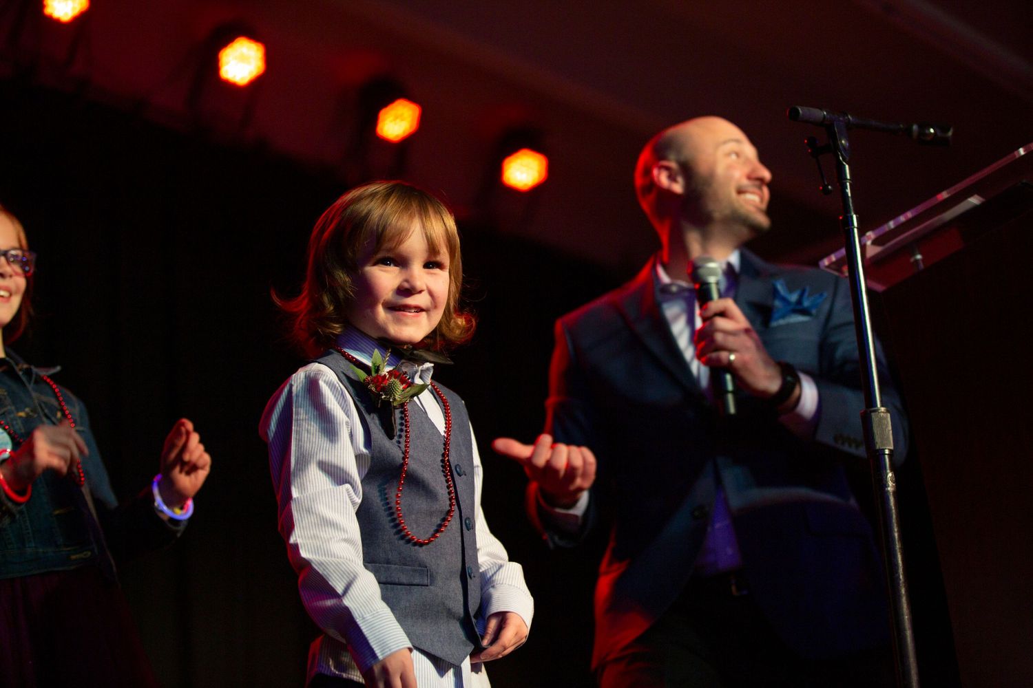 leukemia society on stage with young participant in salt lake city event venue -Corporate event photography in Utah