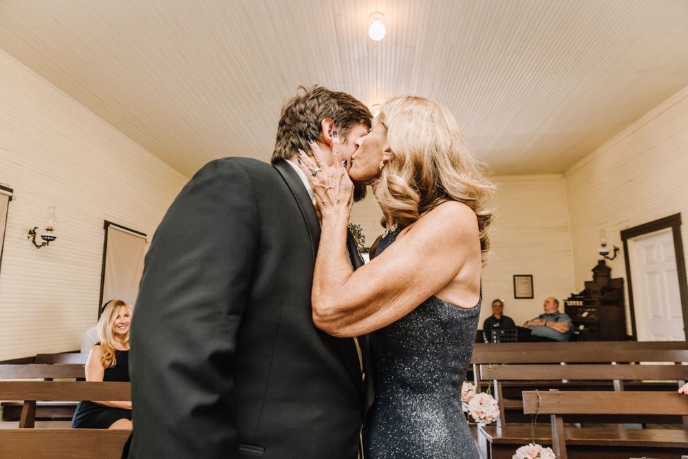 An emotional moment shared during an indoor ceremony between two people.