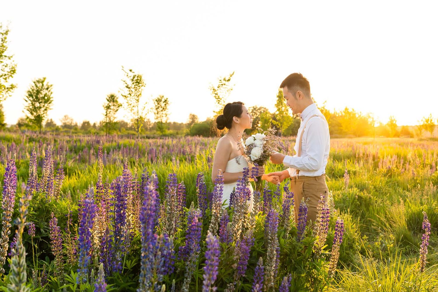 Husband and wife exchanging vows at sunset in Van Lierop Park.