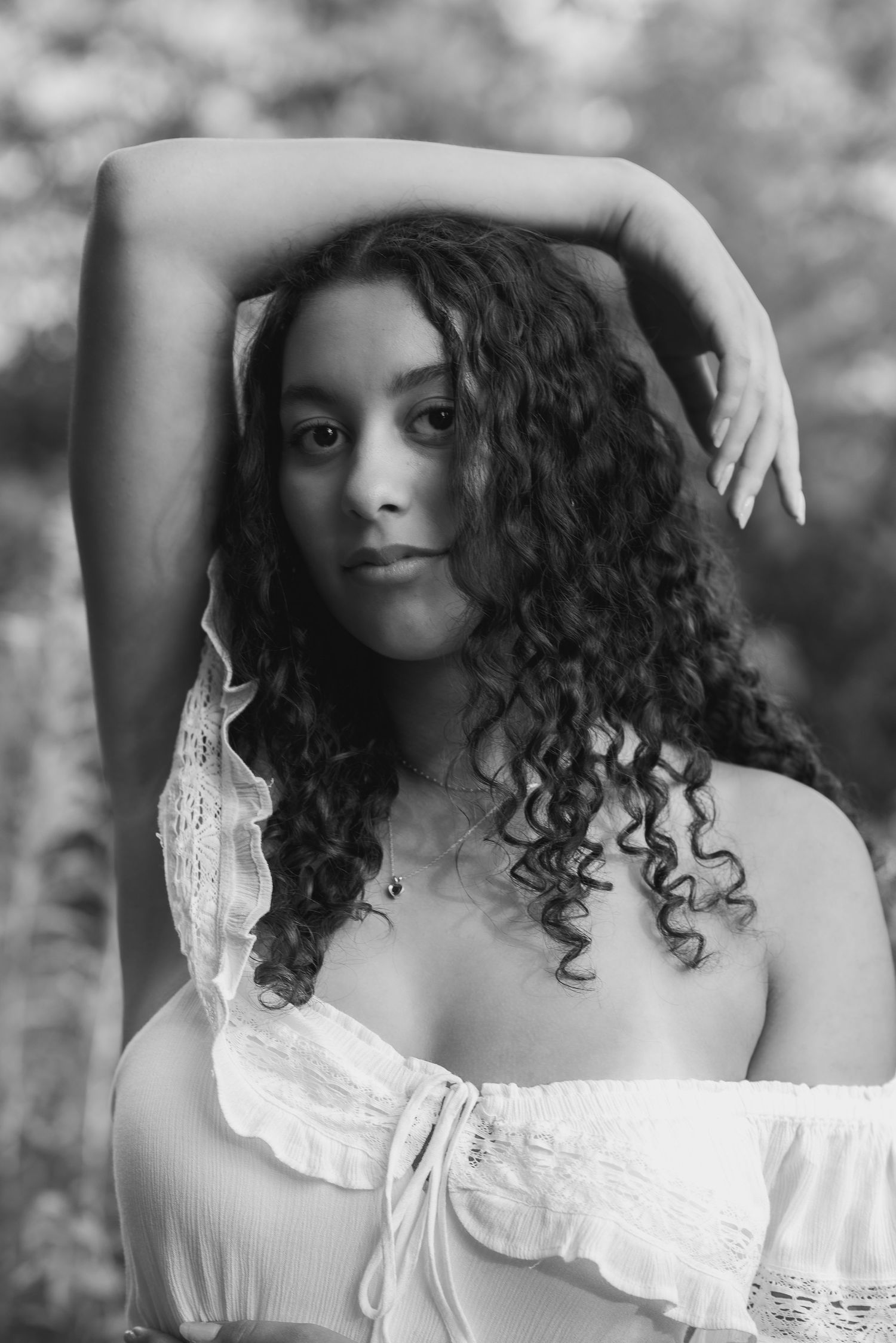 Black and white portrait with curly hair and vintage style dress.