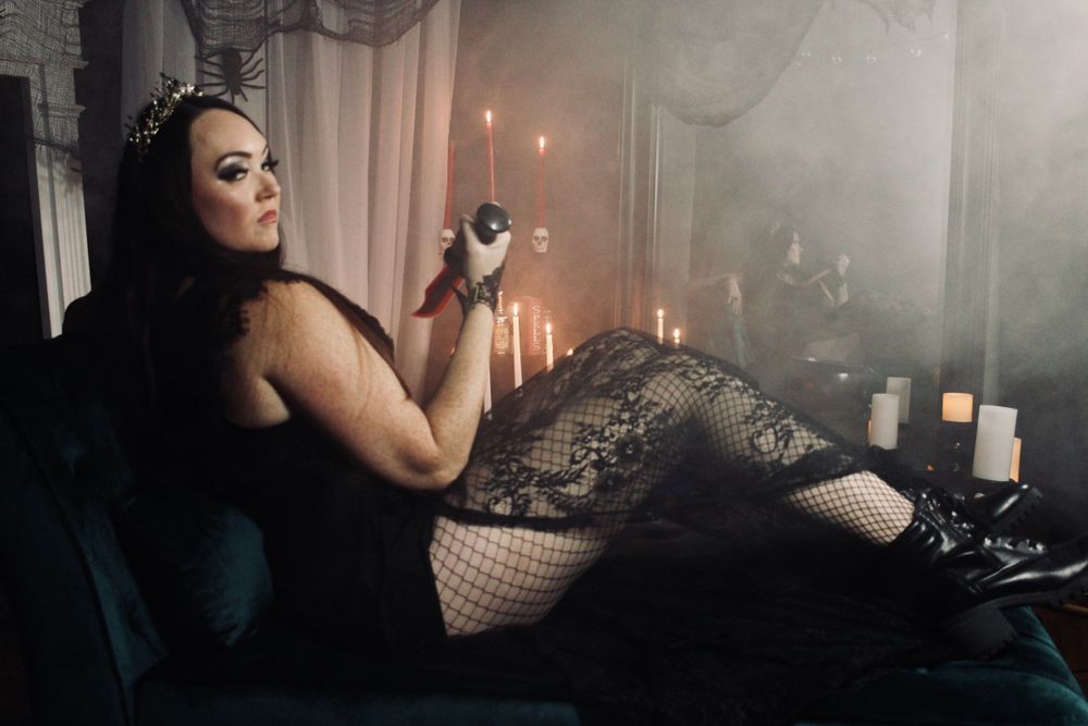 Atmospheric boudoir portrait with candlelight and lace lingerie.