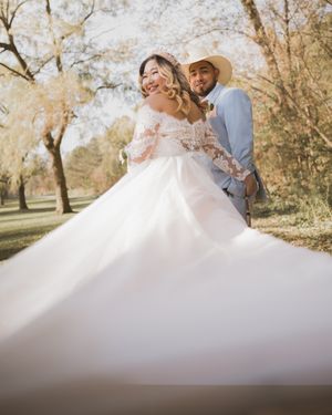 Groom and Bride looking back at the camera while dress is flowing