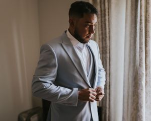 Groom fixing his suit