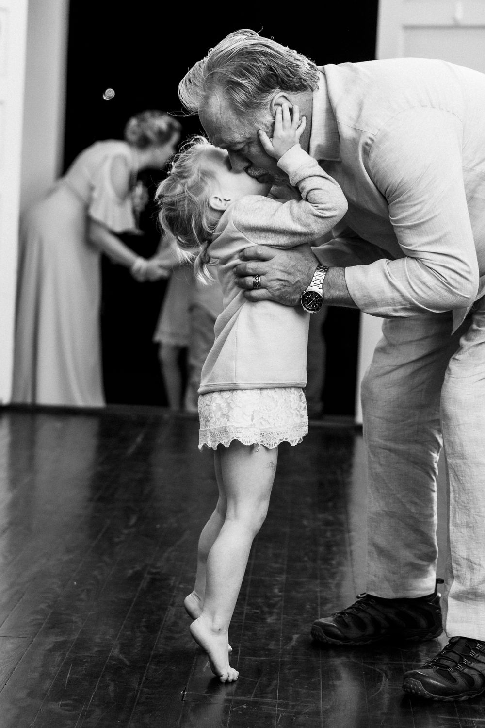 Black and white photo of couple's feet during an intimate dance moment.