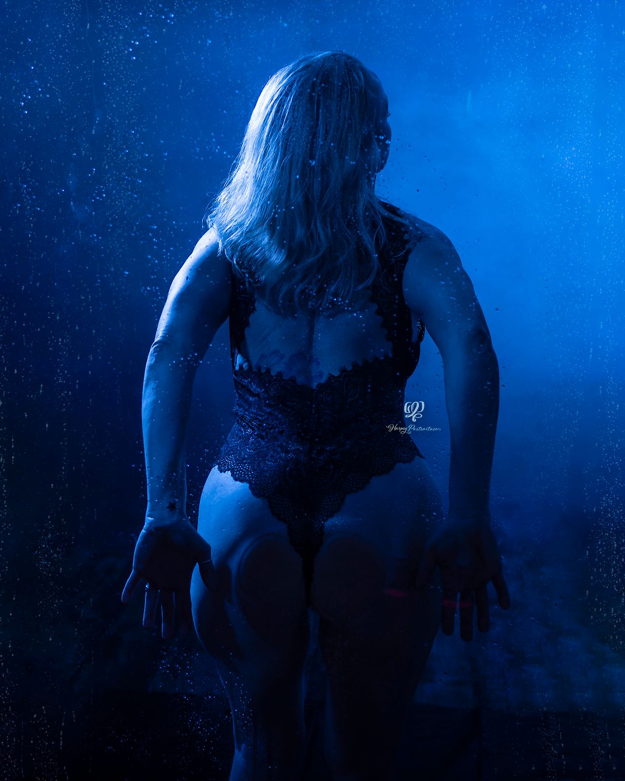 Steamy shower boudoir session, blue lights, butt pressed to glass shower door; Lexington, SC boudoir photographer