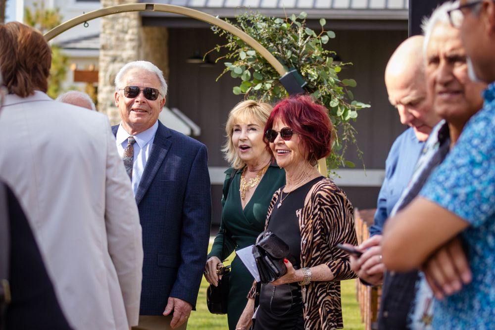 Wedding guests mingling and socializing at an outdoor garden party.
