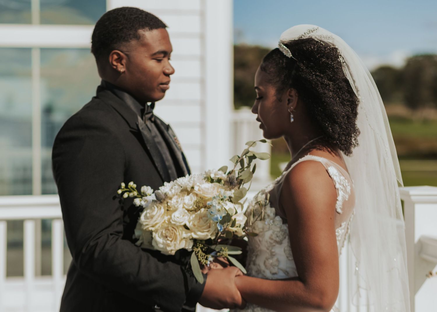 A happy couple shares an intimate moment together during their outdoor wedding ceremony in Warwick, RI.