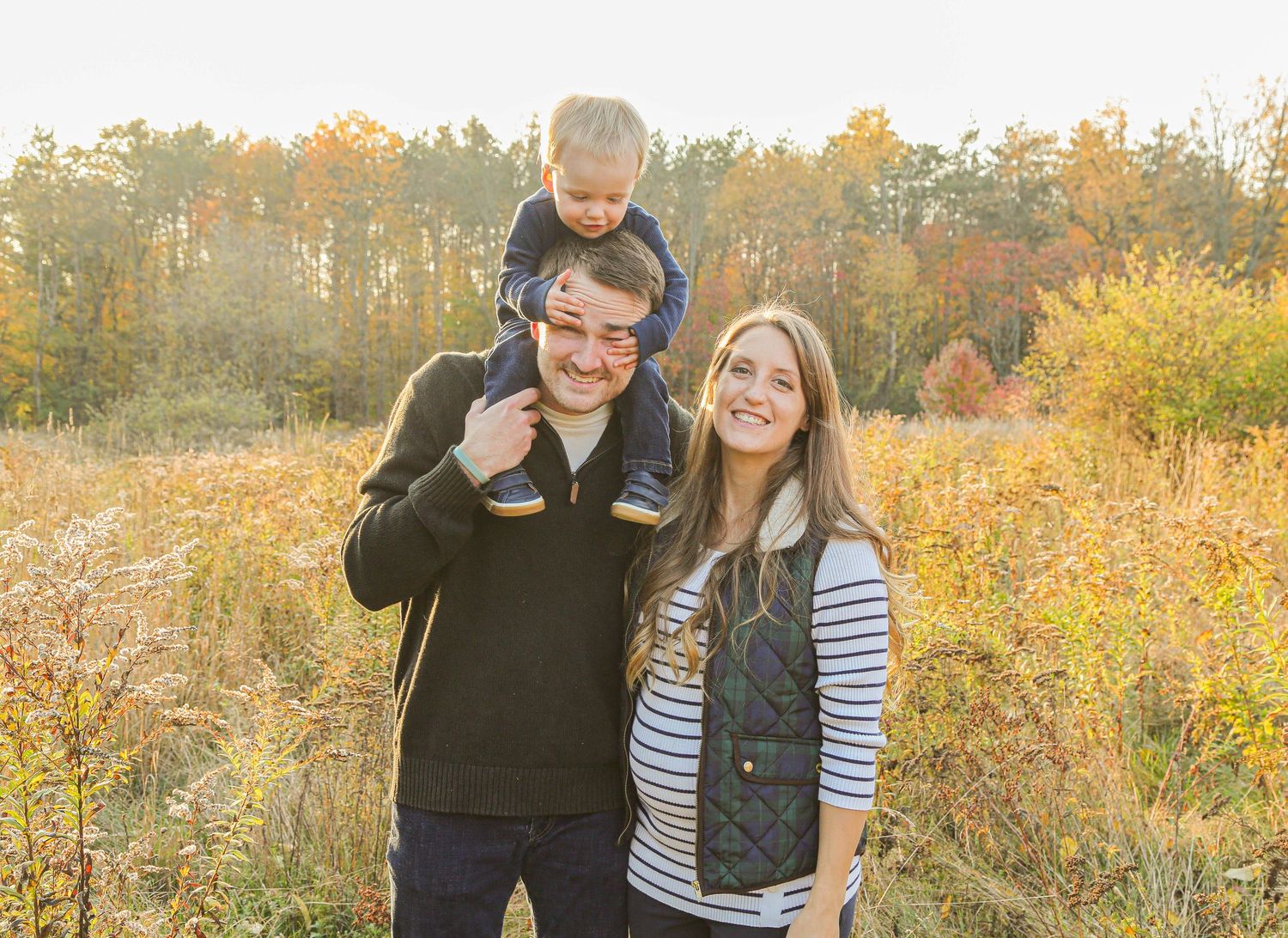 fall family photo with mom, dad, and son
