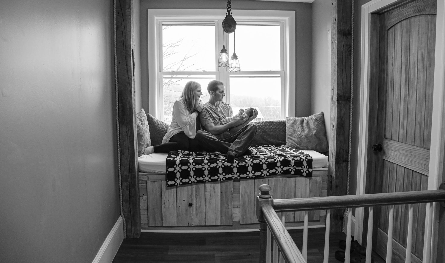 newborn photo with mom, dad and newborn in their home in Cortland, NY