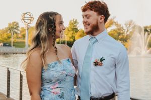 Homecoming couple in front of water