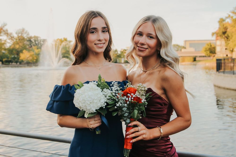 Homecoming photo of friends in front of water