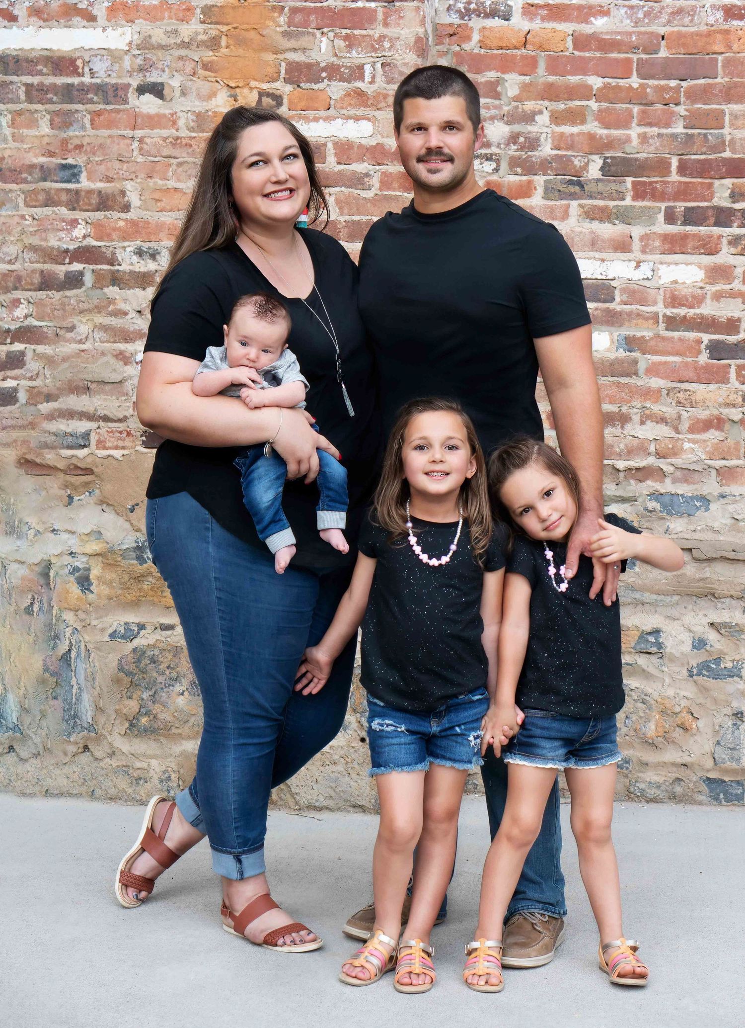 family smiles in downtown Winchester