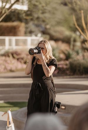 Professional photographer takes pictures at outdoor venue. Mountain shadows wedding venue in Scottsdale, Arizona.