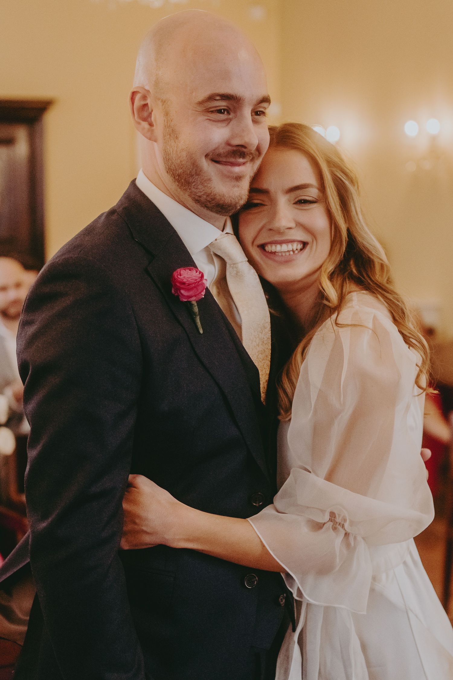 A joyful moment captured between newlyweds during their intimate indoor wedding celebration.