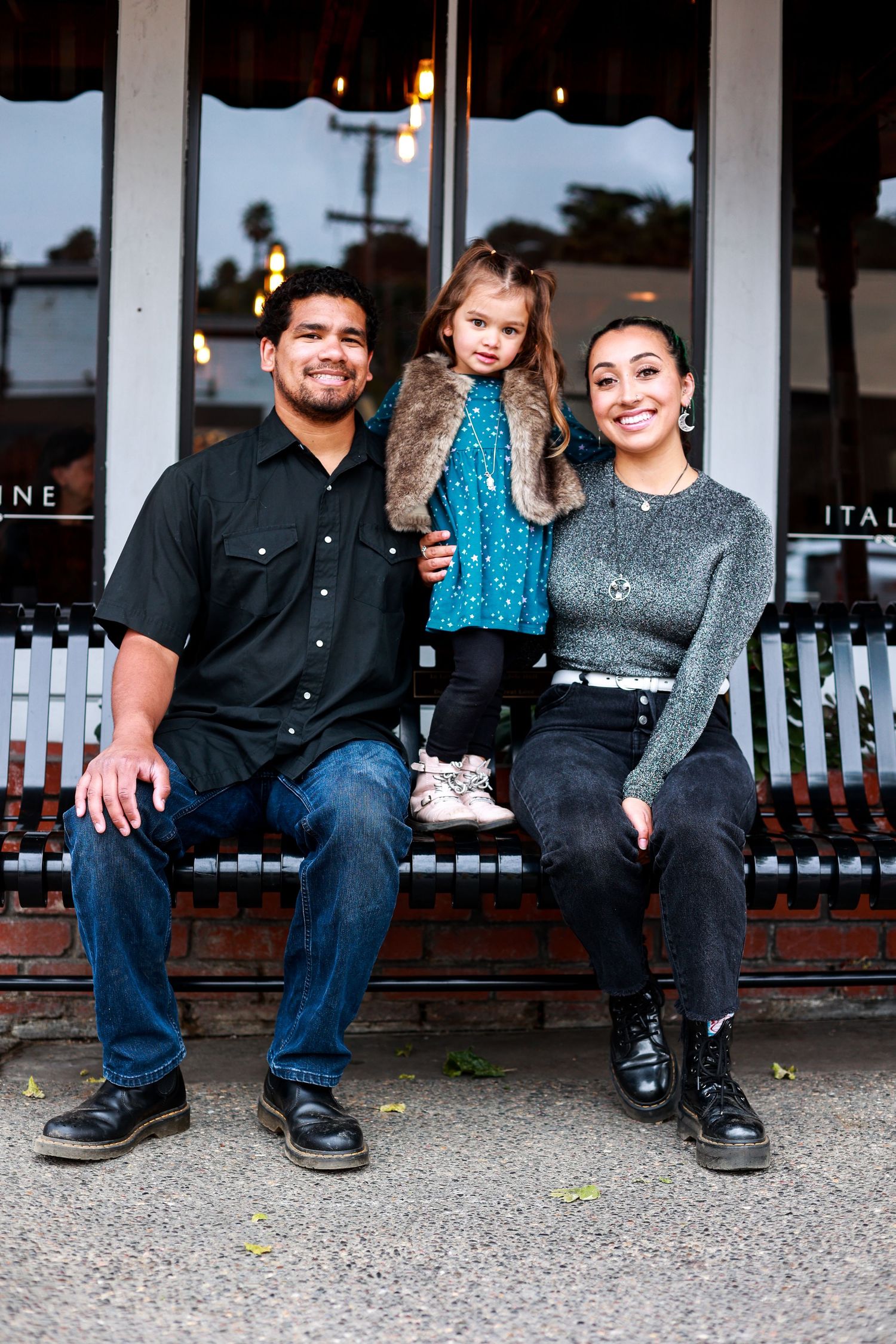 Family sits on bench in the Village of Arroyo Grande