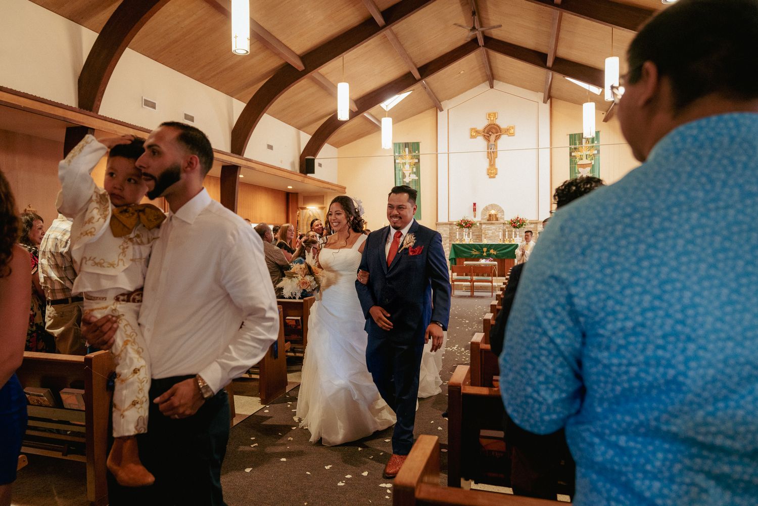 Bride and groom exit church wedding in Portland with confetti.
