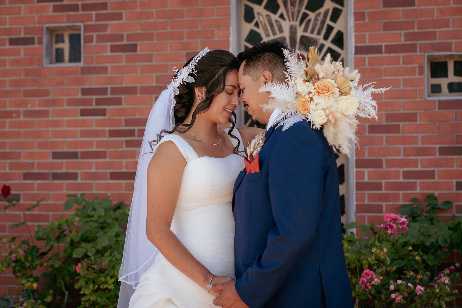 Interracial couple forehead to forehead, sweet PDX church wedding moment.