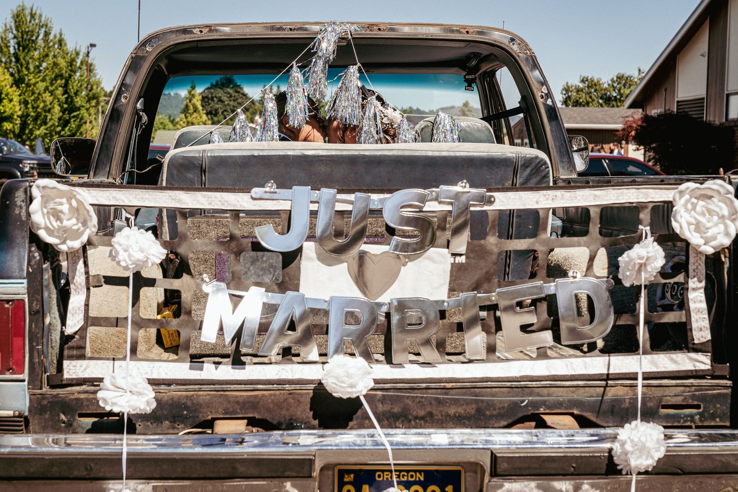 Vintage truck with “Just Married” sign, rustic PNW wedding sendoff.