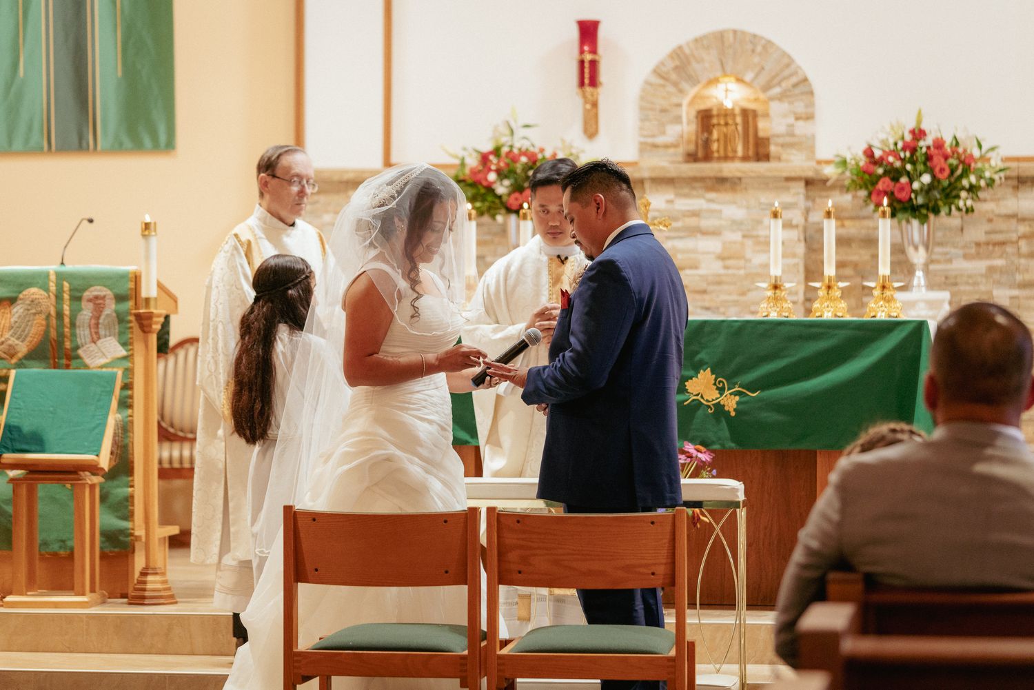 Catholic wedding ceremony with kneeling couple, traditional Portland church.