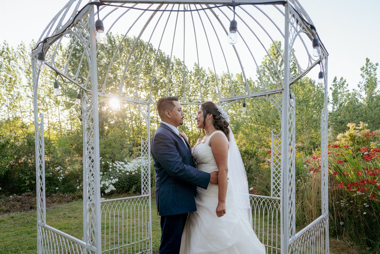Latina groom and bride under gazebo, Portland wedding moment.