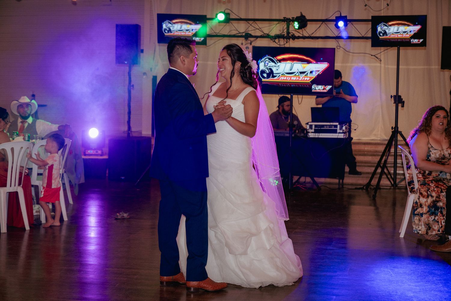 First dance at wedding reception with DJ lights, PDX celebration.
