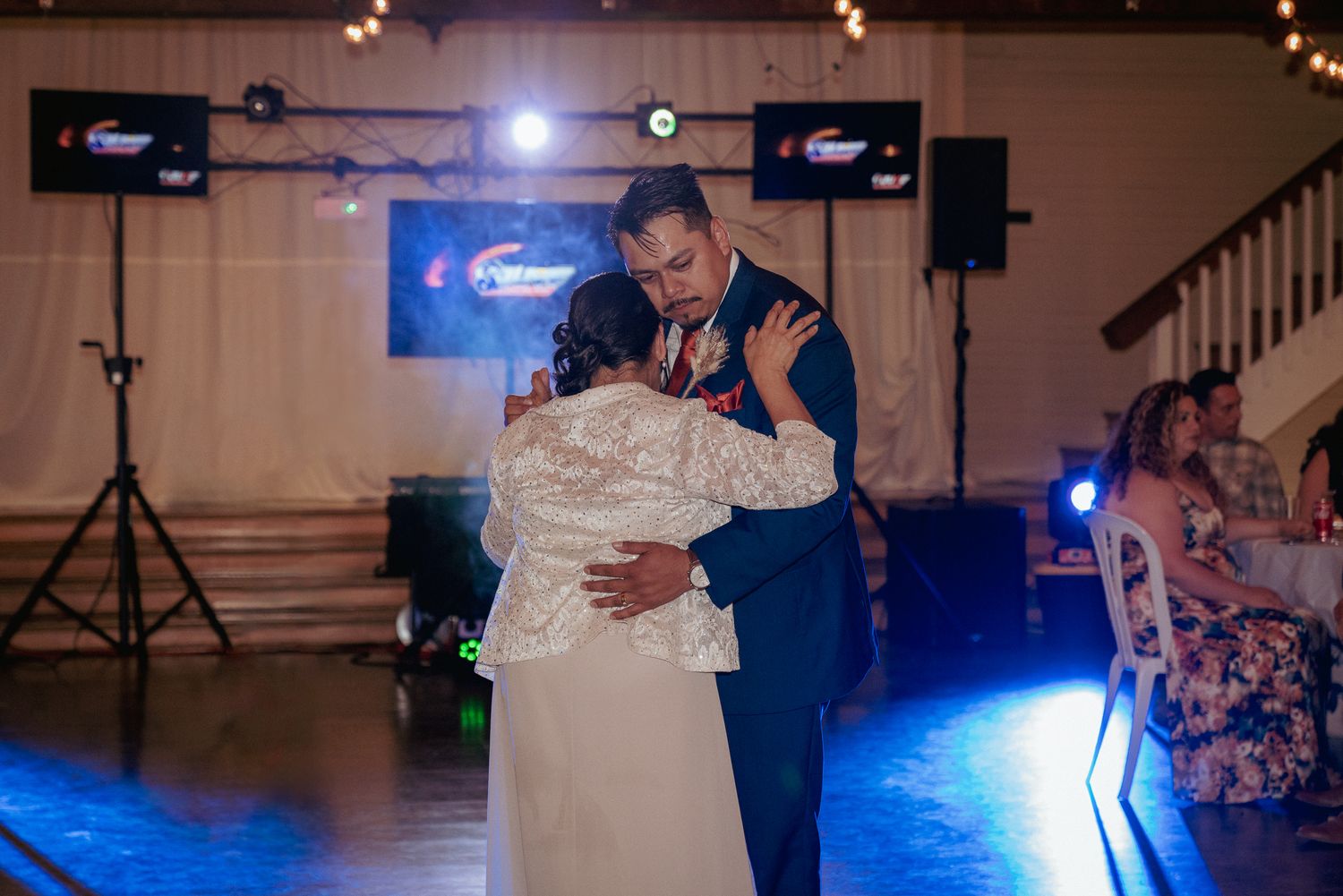 Groom dances with mom at wedding, joyful PNW celebration.