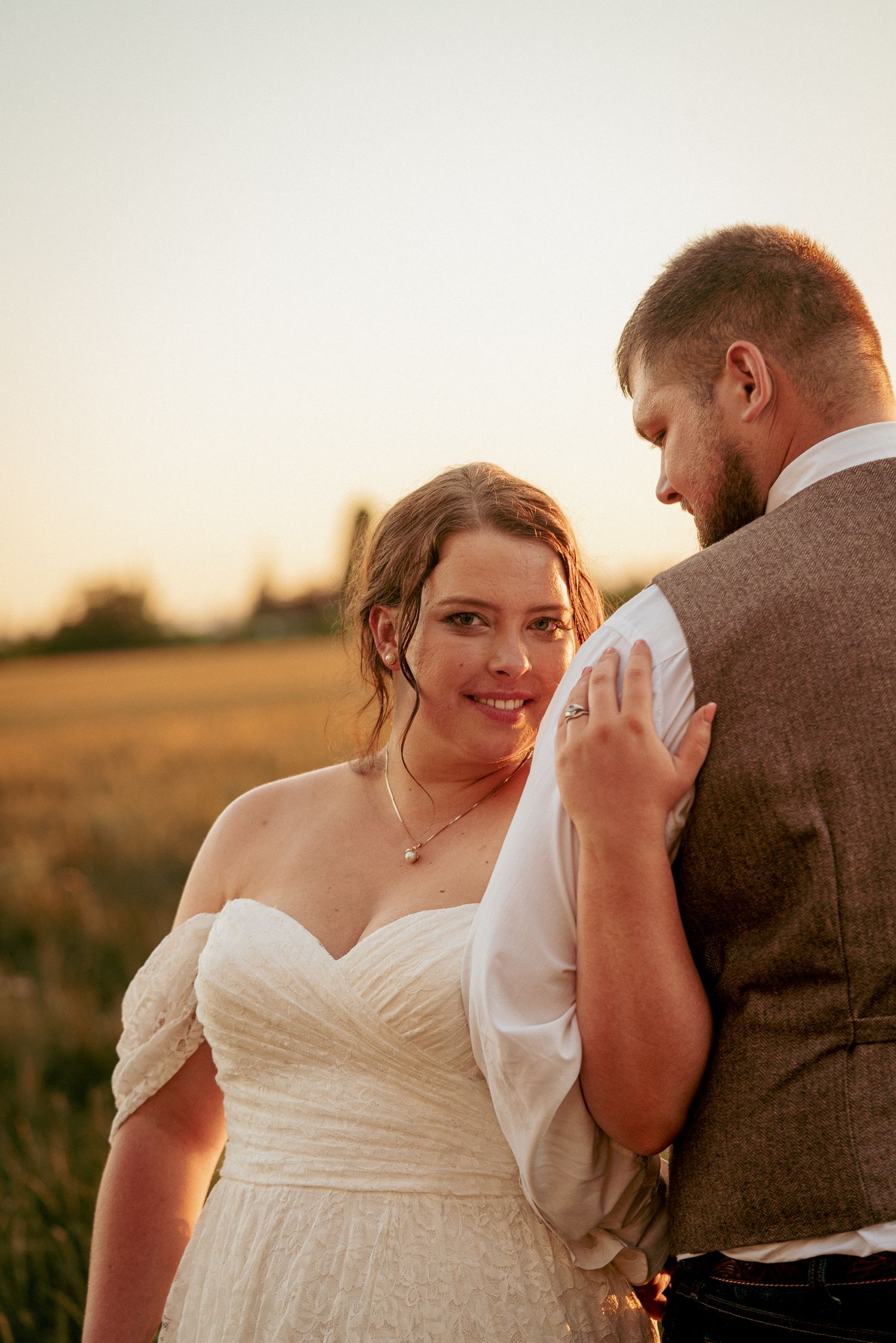 Bride looks back at groom during golden hour in Central Oregon.