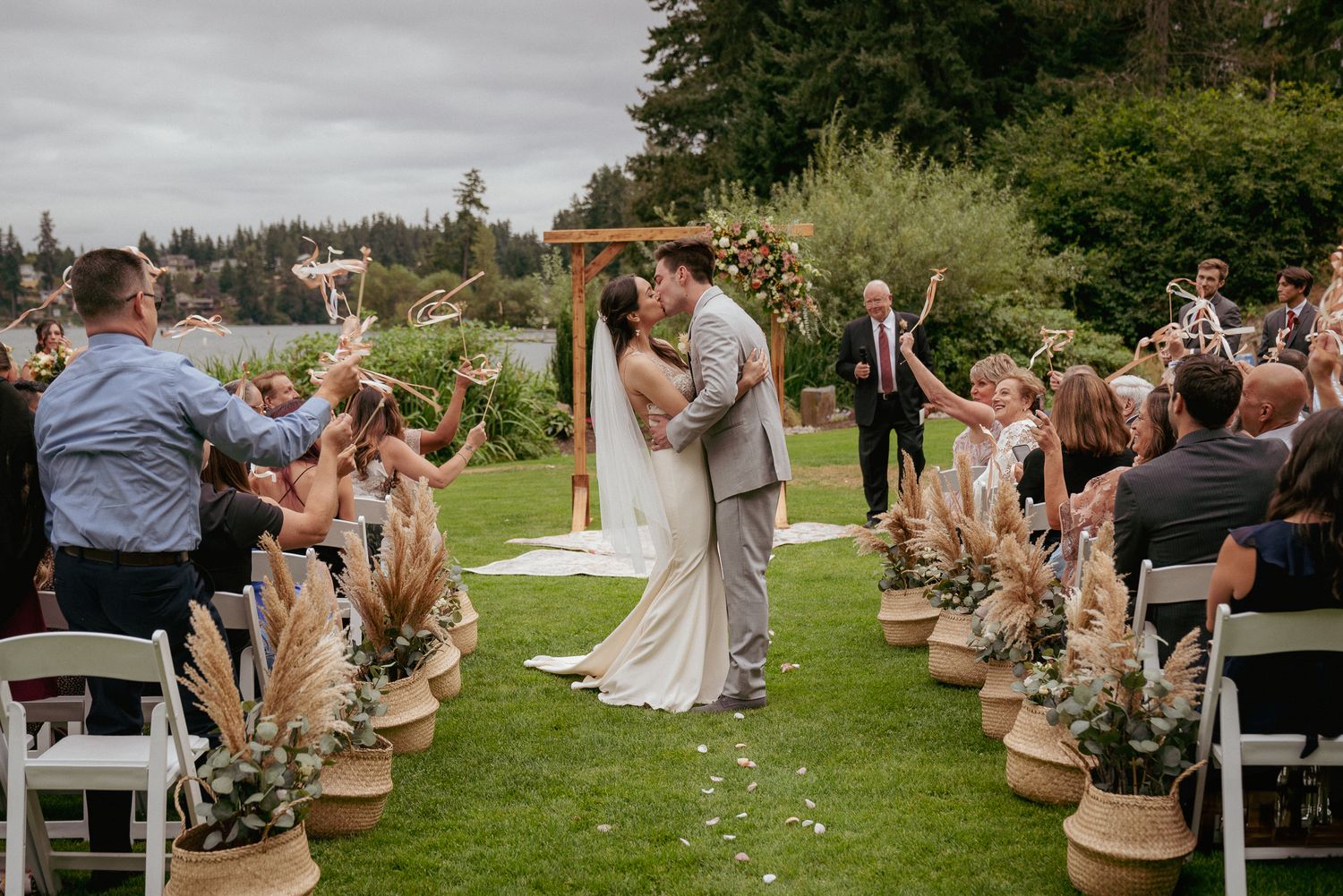 Interracial couple shares first kiss at outdoor Oregon garden wedding ceremony.