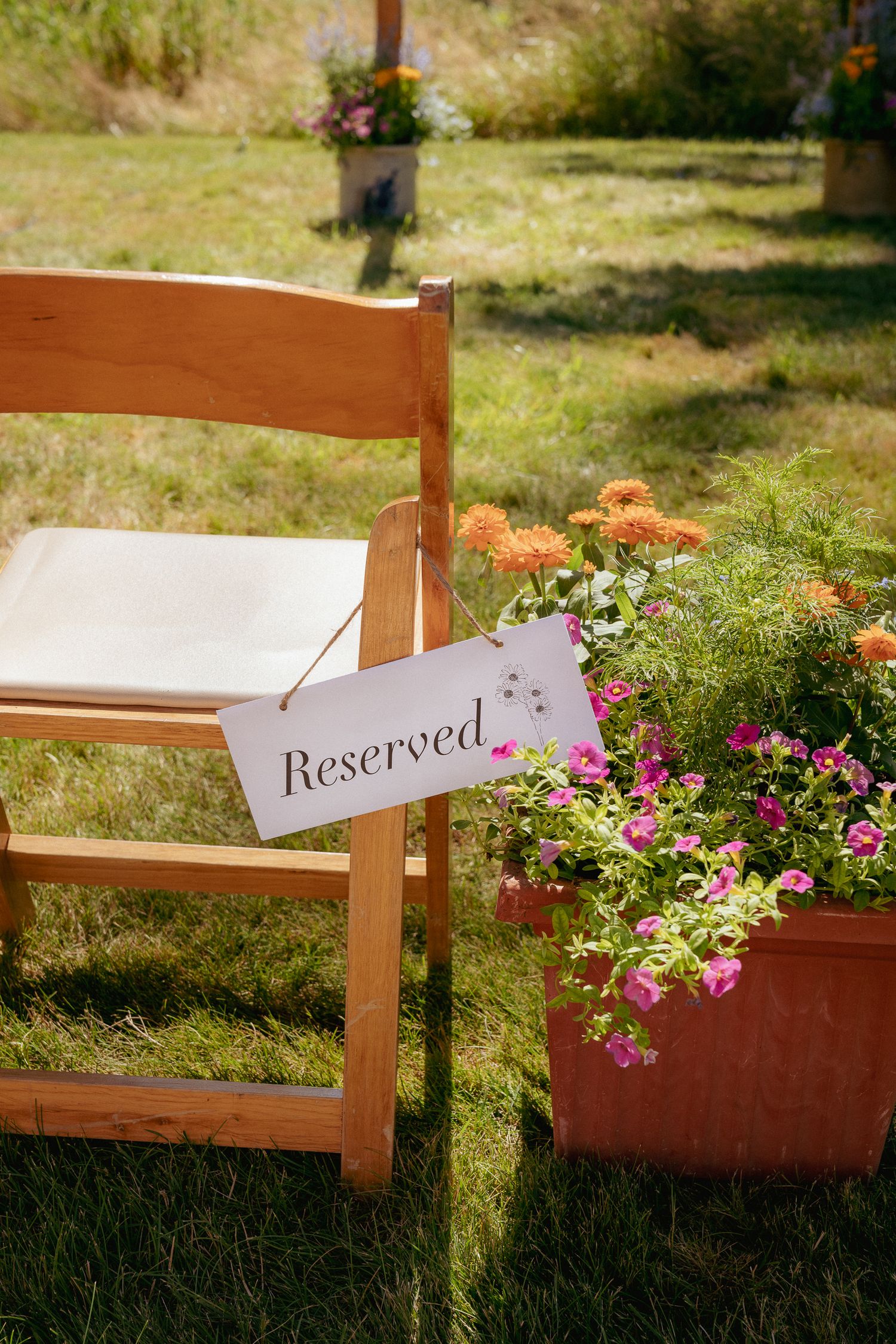 "Reserved" ceremony chair with wildflowers, intimate Oregon wedding.