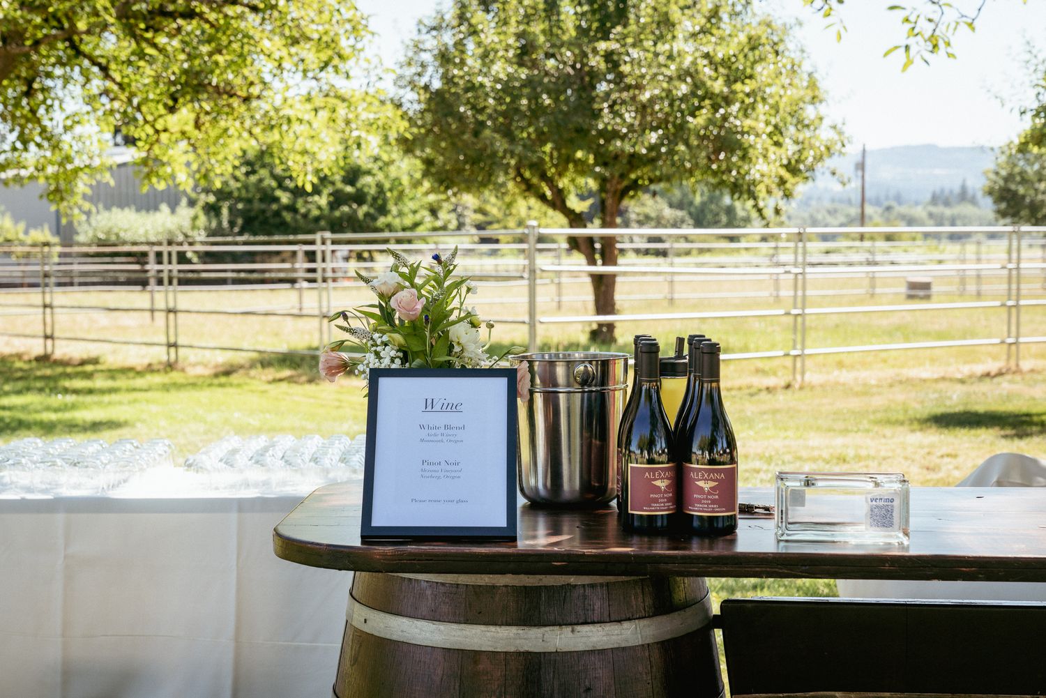 Outdoor wedding bar setup with local wine, Portland farm venue.