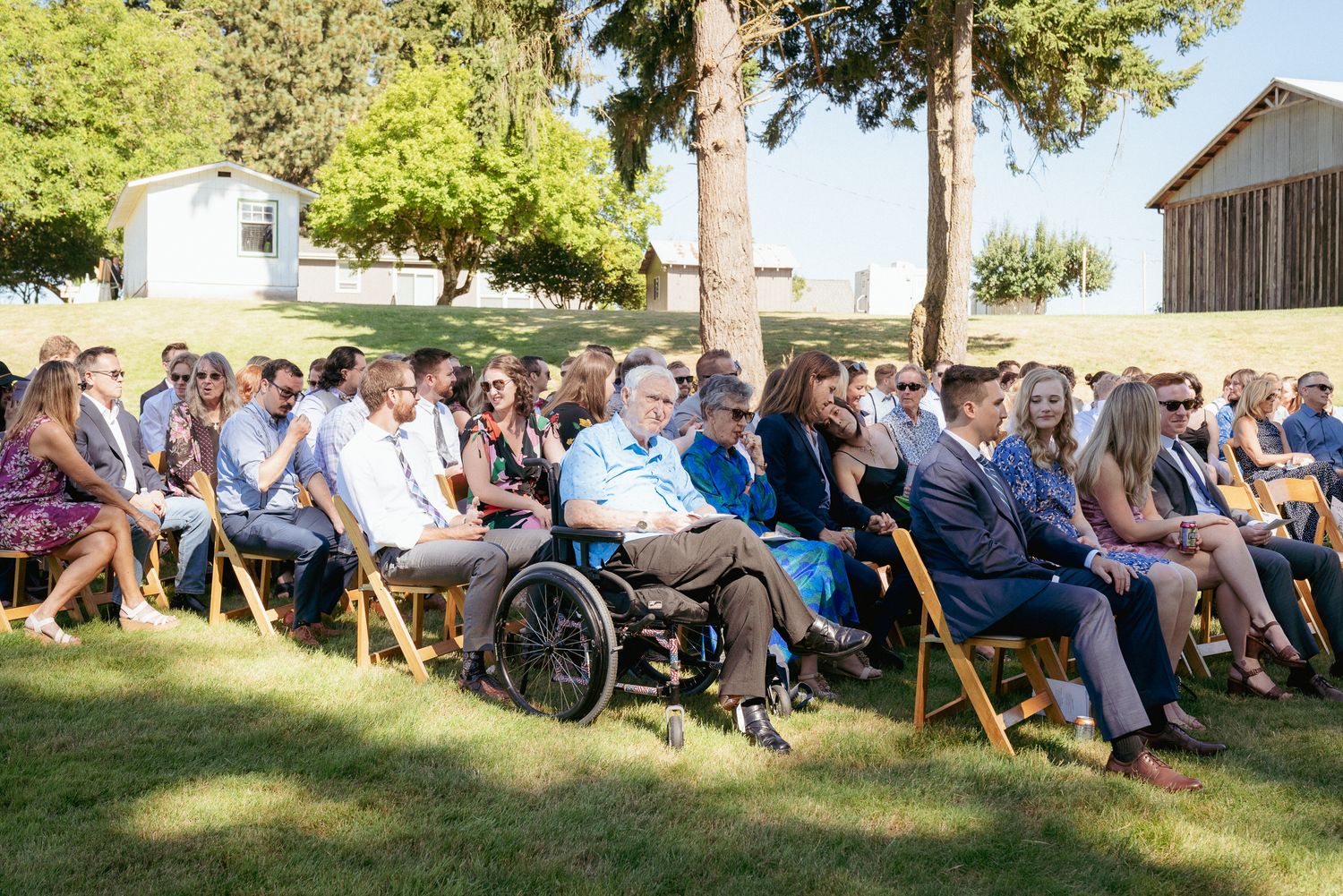 Guests watch ceremony, including guests in wheelchairs, accessible PNW wedding.