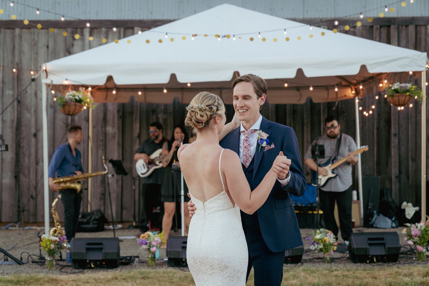 First dance under string lights, Portland backyard wedding with band.