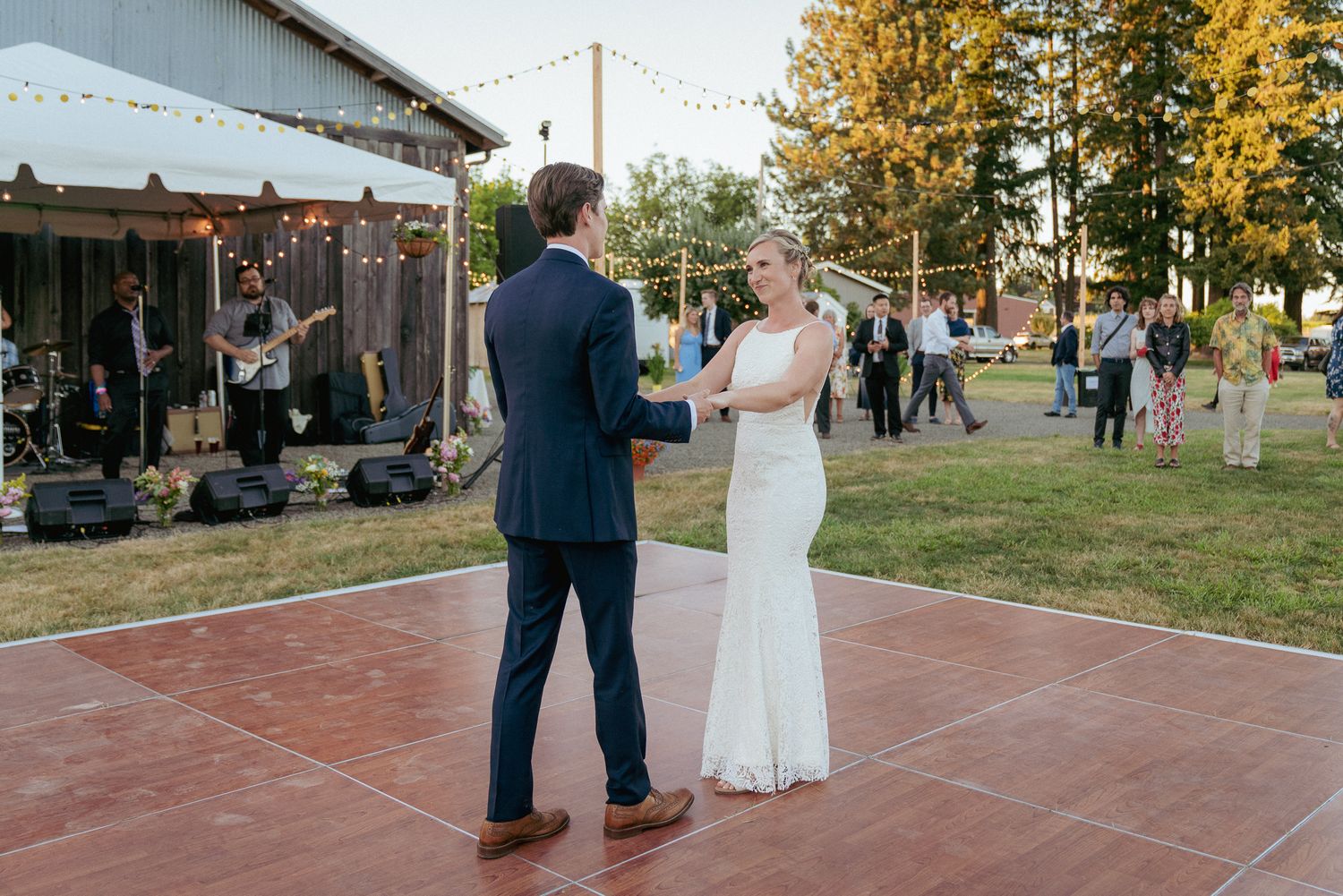 First dance at sunset reception, live band, open-air Oregon venue.