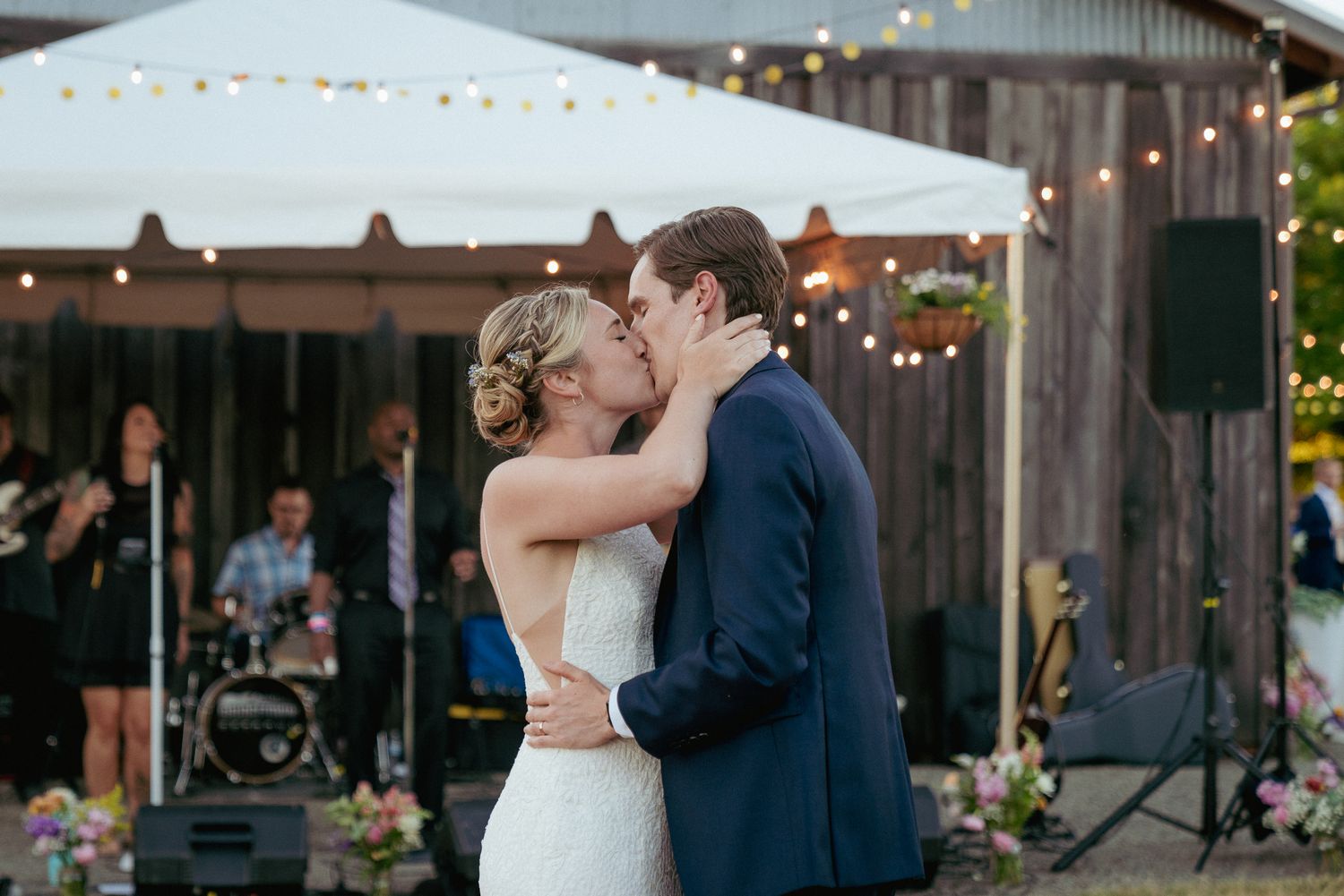 First kiss as newlyweds, intimate backyard wedding in Portland.