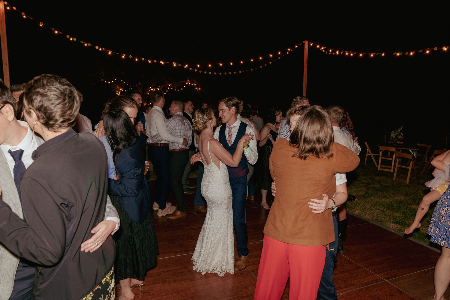 Dance floor fun under string lights, backyard Oregon reception.
