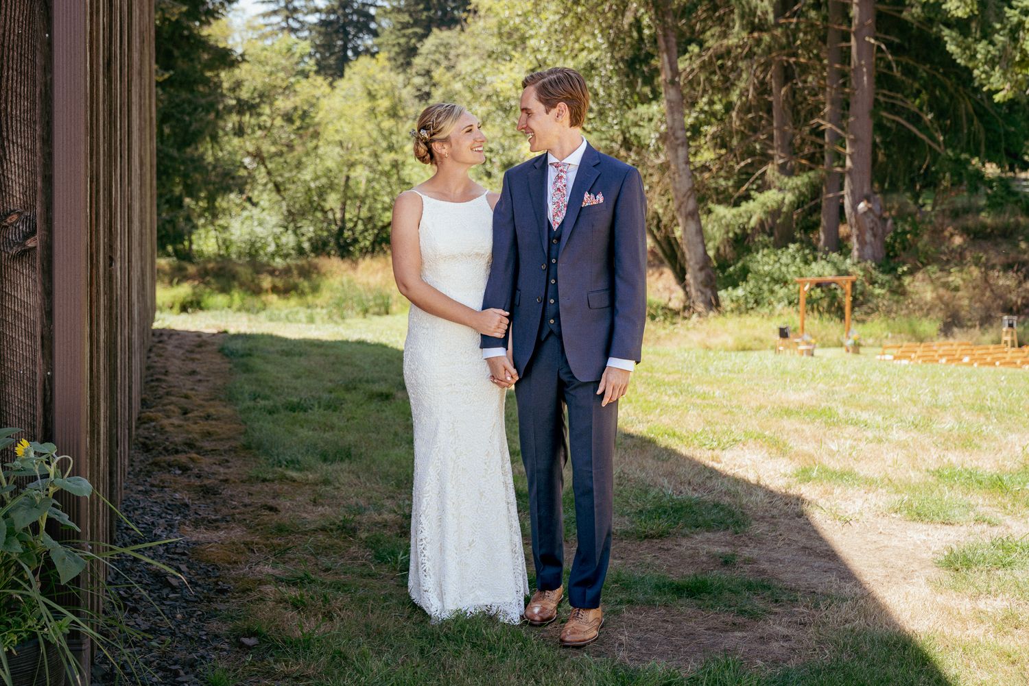 Bride and Groom smiles while walking in forest, elegant summer wedding.