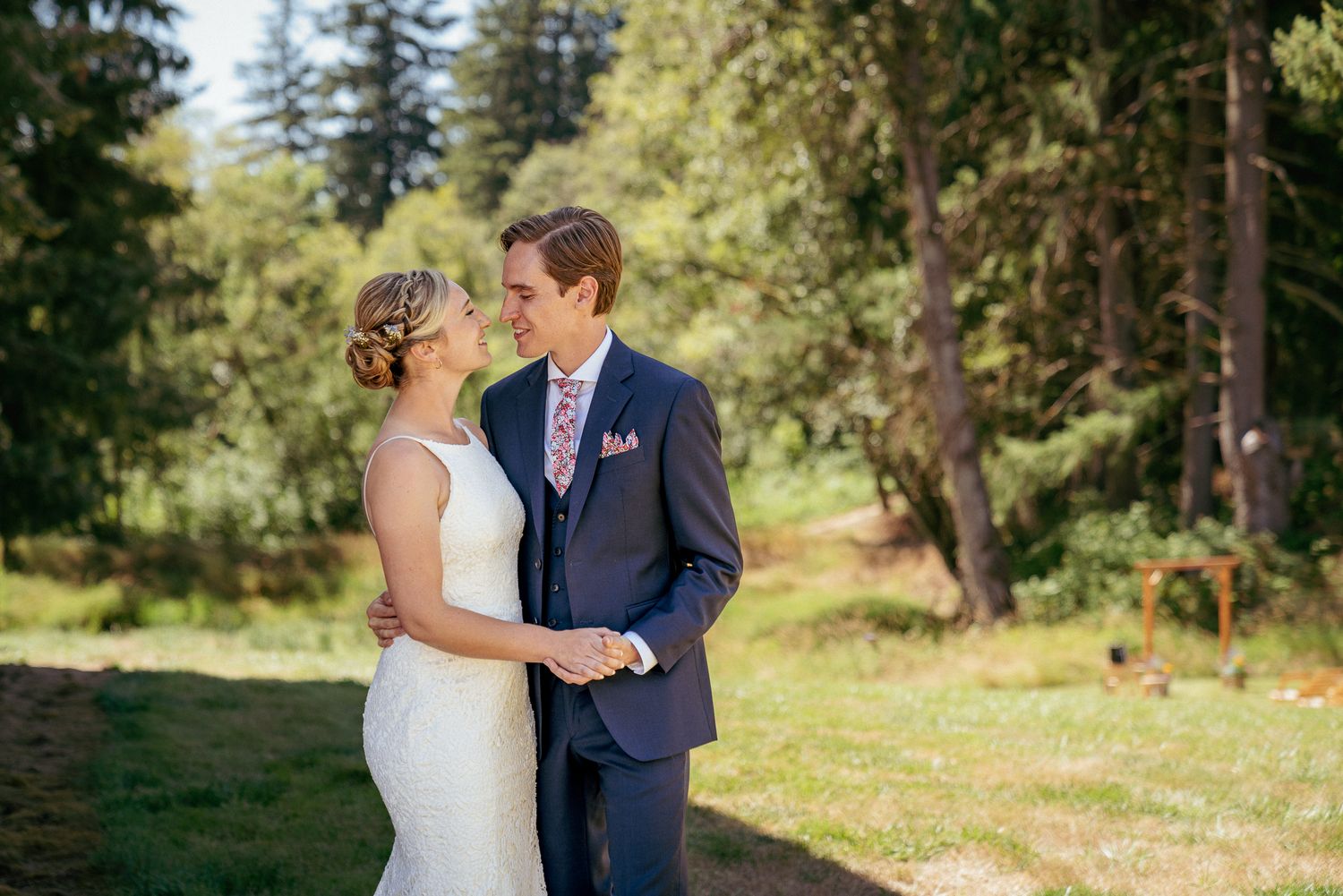Bride and groom smile during golden hour portraits, elegant Oregon garden wedding.