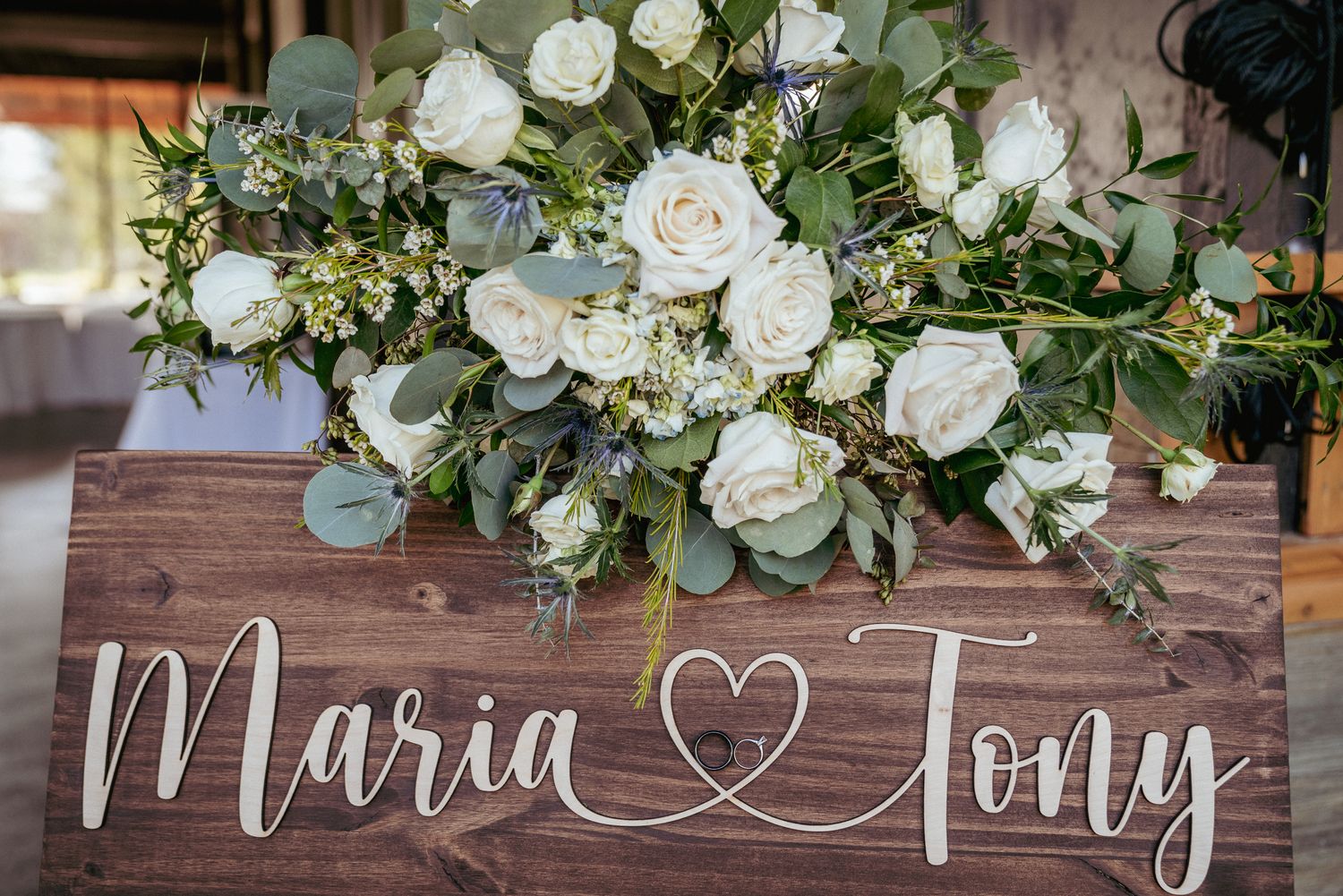 White roses and greenery wedding sign, modern garden ceremony decor.