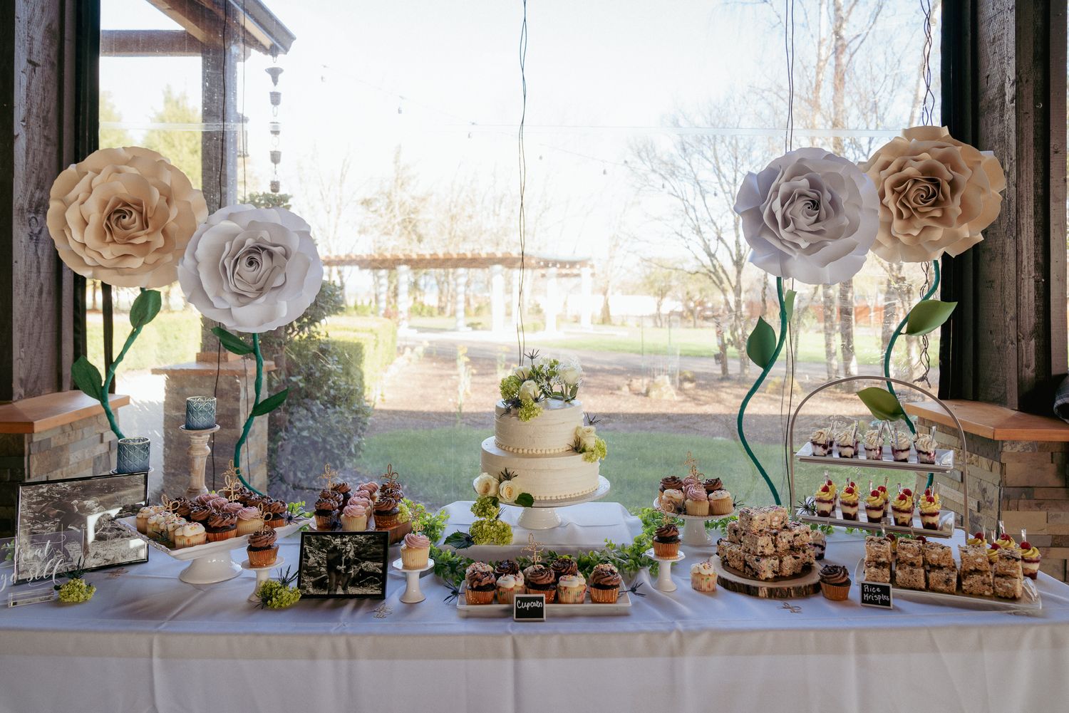 Dessert table with cake, cookies, and cupcakes, Portland wedding setup.