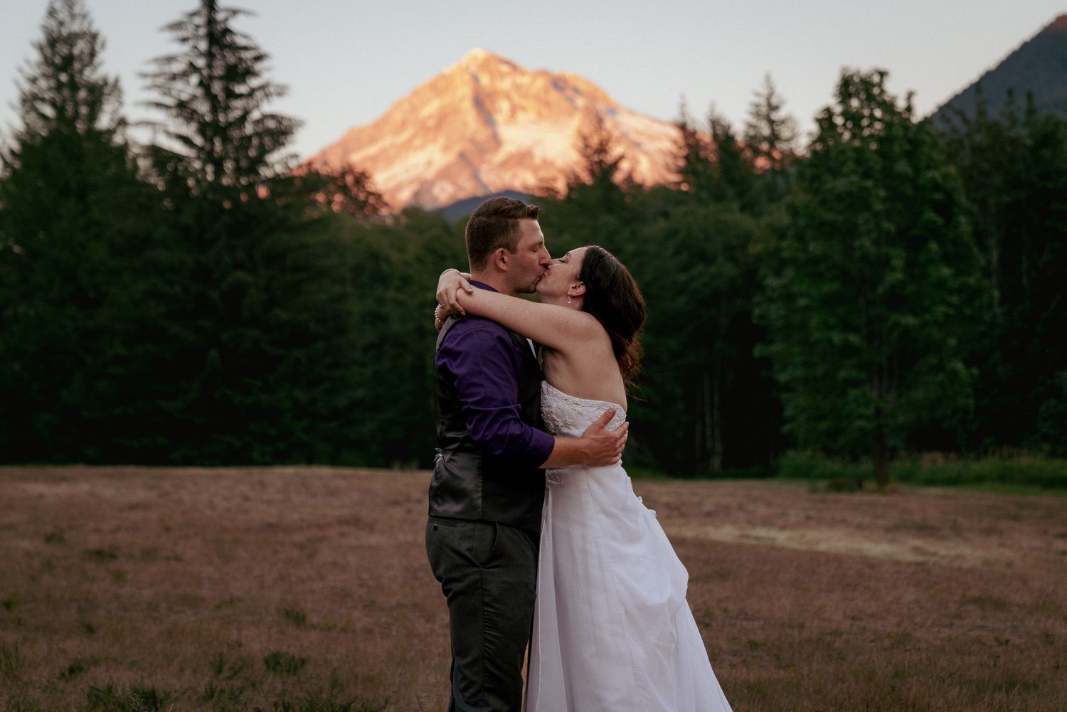 Bride and groom kiss in front of Mt. Hood, scenic Oregon elopement.